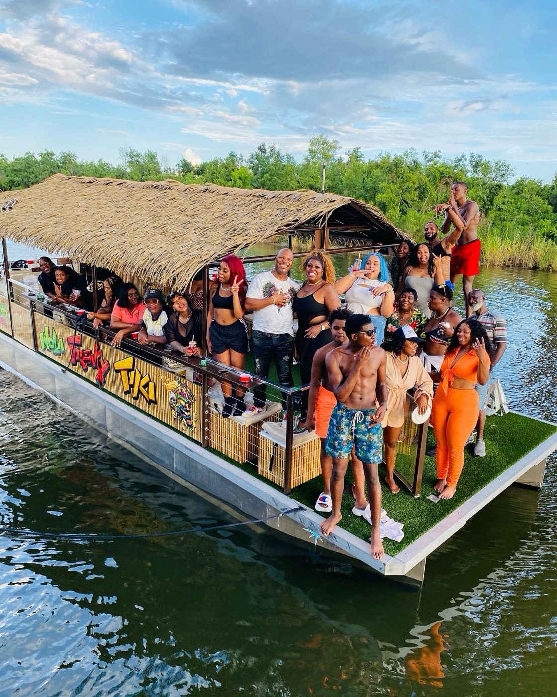 The Freaky Tiki thatched-roof party boat loaded with guests cruising the bayou